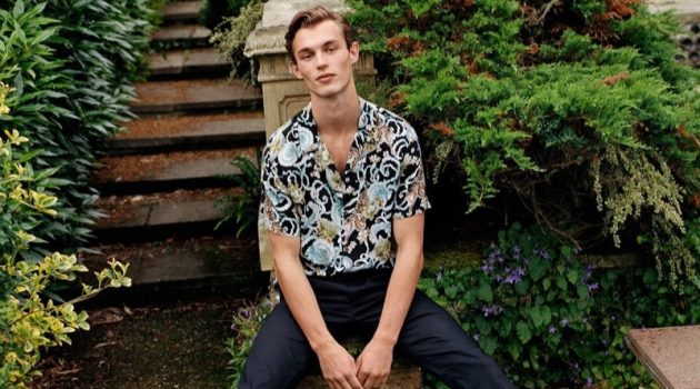 Kit Butler models a short-sleeve printed shirt with smart pants from Mango.