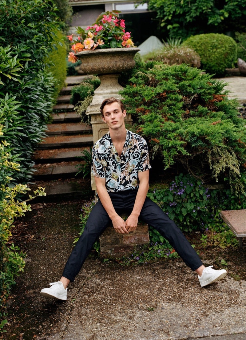 Kit Butler models a short-sleeve printed shirt with smart pants from Mango.