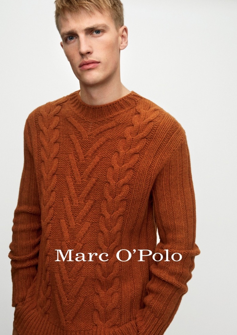 Victor Nylander dons a brown cable-knit sweater from Marc O'Polo's fall-winter 2020 casual collection.