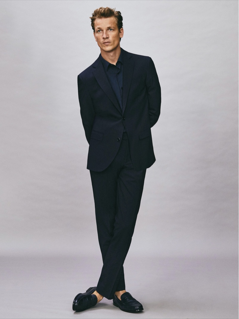 Taking to the studio, Hugo Sauzay sports Massimo Dutti's comfort slim fit navy suit.