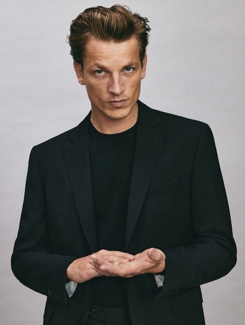 French model Hugo Sauzay dons a black wool slim fit blazer from Massimo Dutti.