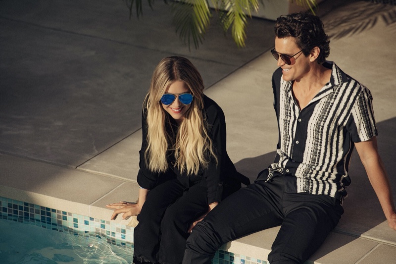 Relaxing poolside, Ashley Benson and Matt Bomer sport Privé Revaux Cliffs sunglasses.