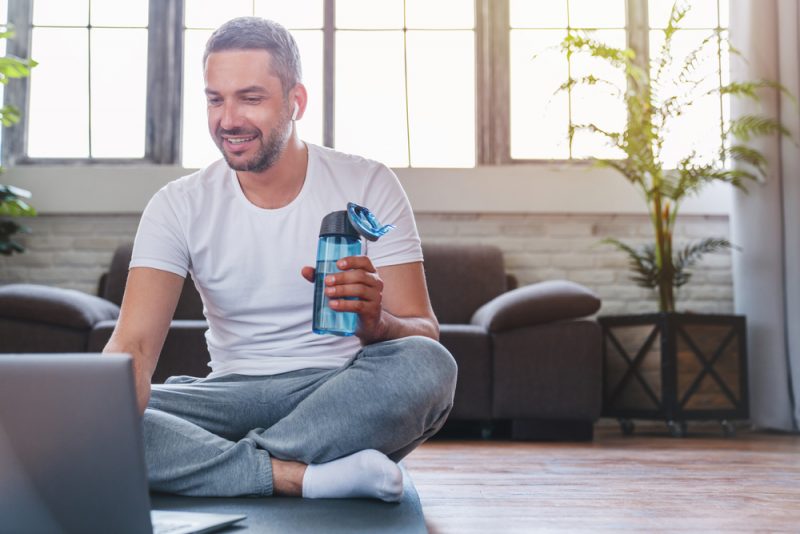 Middle Aged Man Bottle of Water Laptop