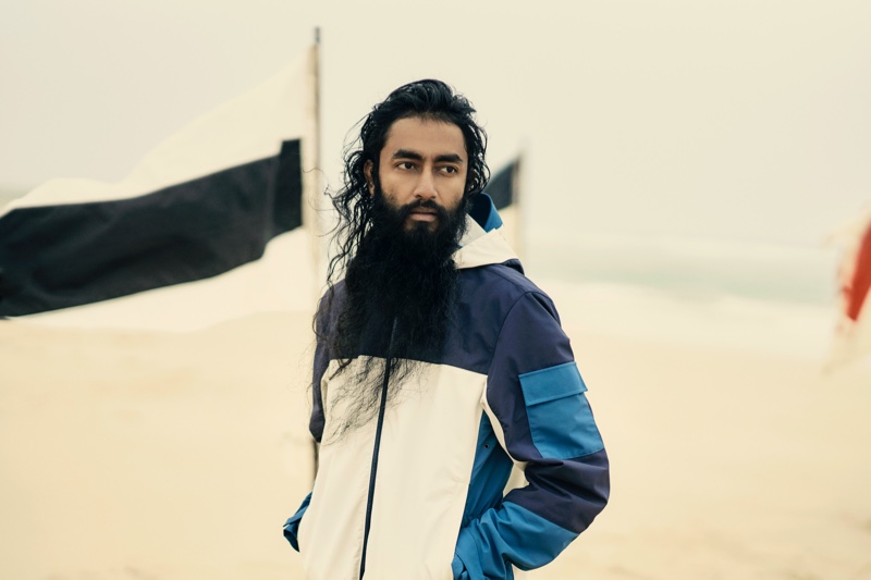 Suren dons a deep sea/pebble water-resistant jacket by Orlebar Brown.