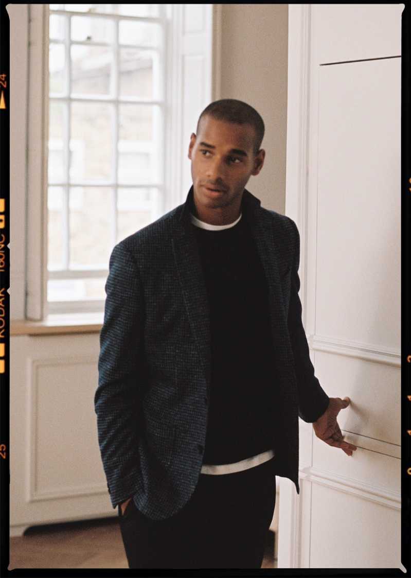 Connecting with Reiss for fall, Sacha M'Baye sports the label's Stelvio blazer, Wessex sweater, and Japane trousers.