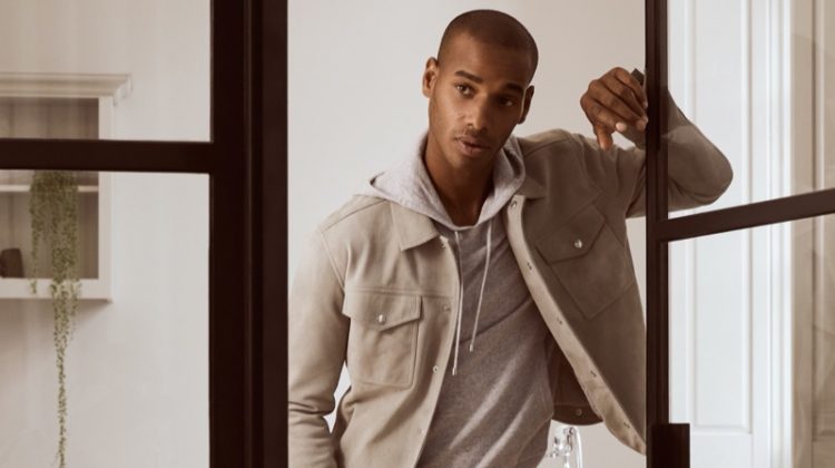 Embracing a wardrobe of neutrals, Sacha M'Baye wears a Jagger jacket with a Santiago hoodie and Monk trousers from Reiss.