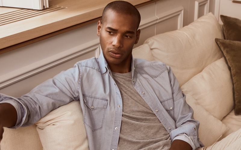 Relaxing, Sacha M'Baye wears Reiss' Devlin shirt and Iona sweater.