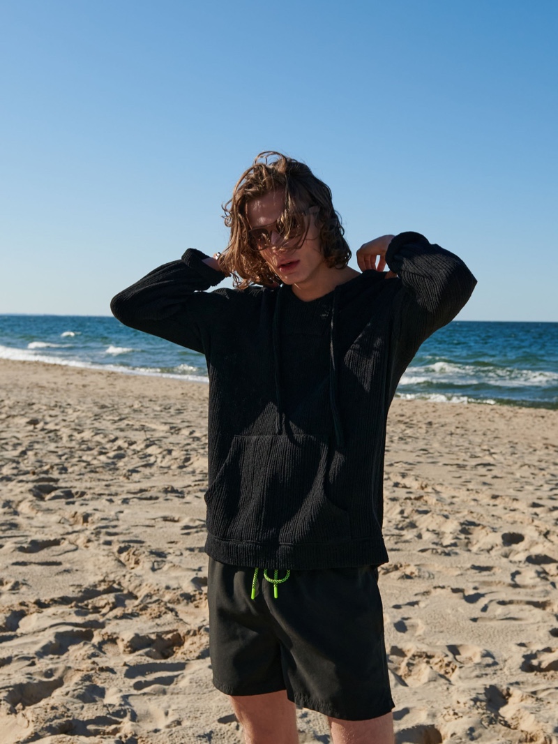 Pawel Feledyn sports a black look from Reserved's swimwear collection.