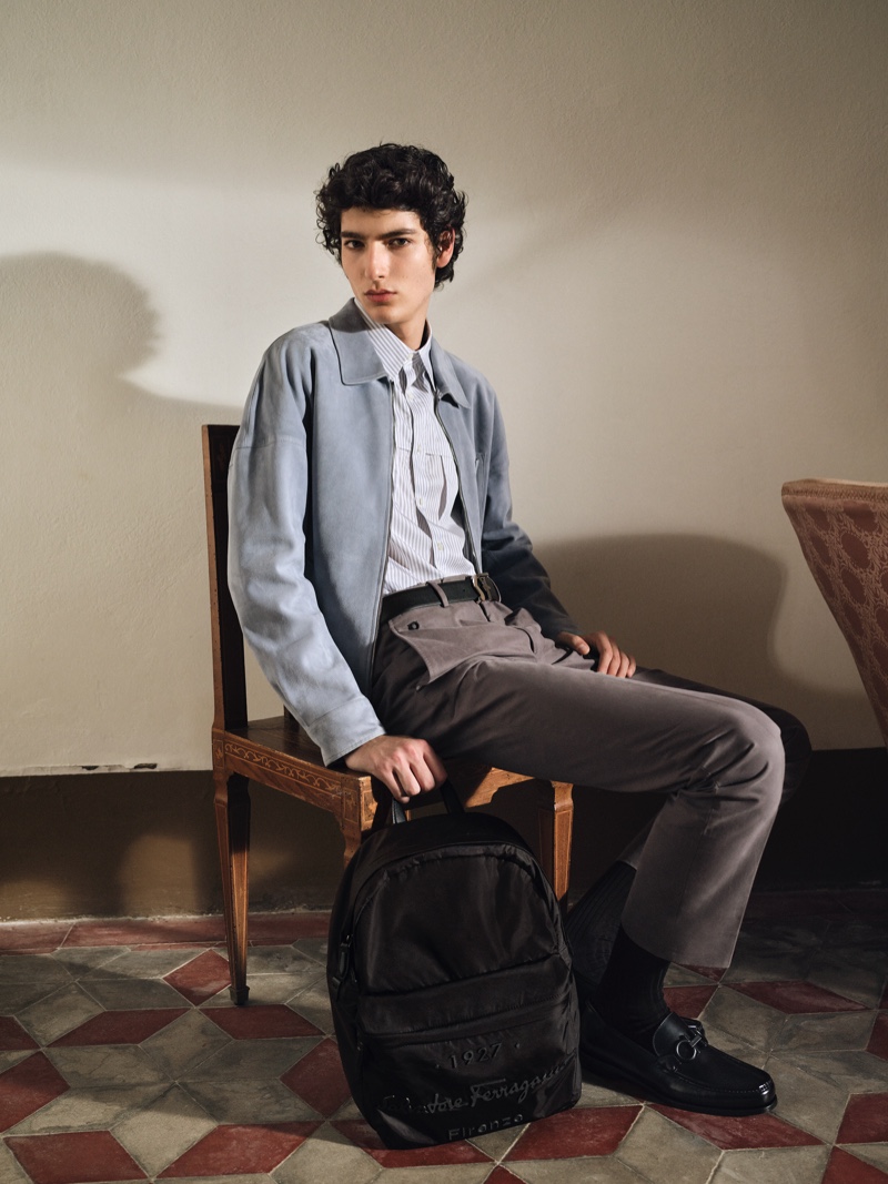 Sitting for a portrait, Mario Lopez takes hold of a backpack from Salvatore Ferragamo's Tornabuoni 1927 collection.