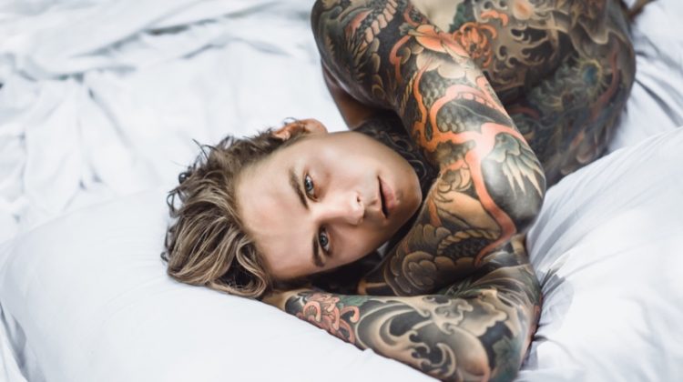 Tattooed Man in Bed Shirtless