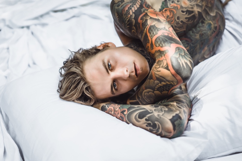 Tattooed Man in Bed Shirtless Tattoo Aftercare