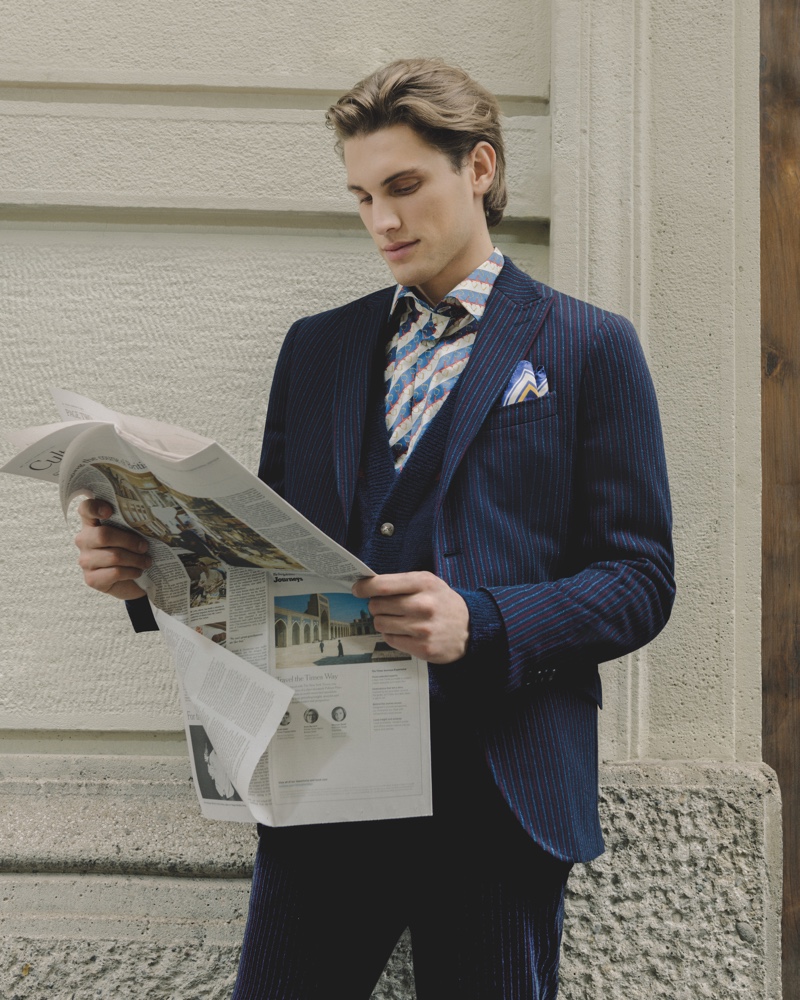 Reading the paper, Maxime Trabouile embraces professional style in an Etro 24 Hour jacket.