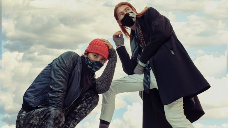 Left: Sooleen wears bomber Hip and Bone, beanie Leone Napoli, sneakers Puma, printed mask Mayer Man Custom, tank and pants House of Dwir. Right: Jayden wears hand warmers Aldo, socks Hudson's Bay, sneakers Hip and Bone, mask, Mayer Man Custom, pants and scarf H&M, sweater and trench Christopher Bates.
