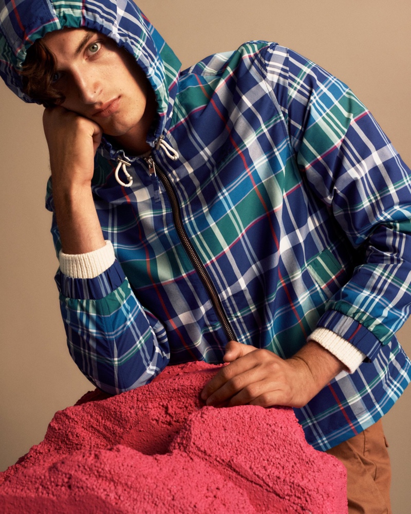 Model Aaron Shandel sports a tartan print hooded jacket by GANT.