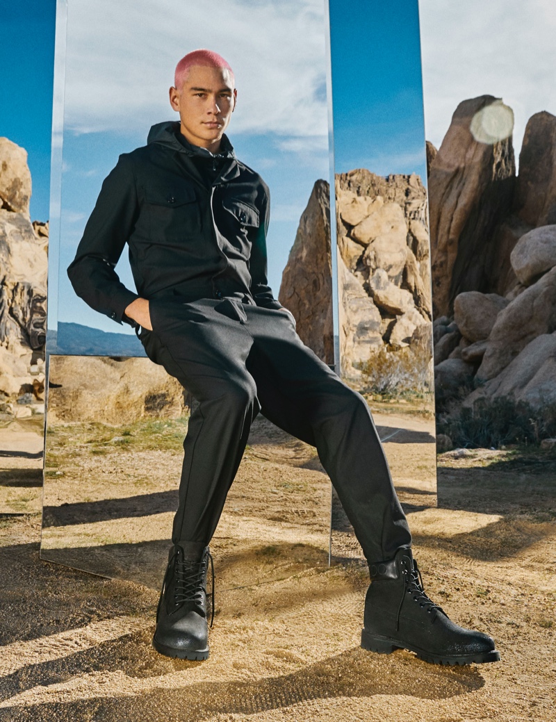 Front and center, Evan Mock appears in the Jimmy Choo x Timberland campaign. The model wears a pair of black gunmetal boots.