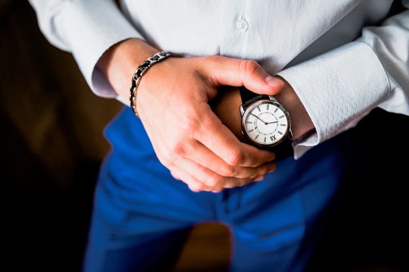 Man Checking Watch Silver Bracelet