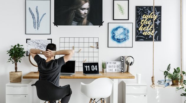 5 Bachelor Pad Wall Décor Tips Man at Desk Artwork on Wall