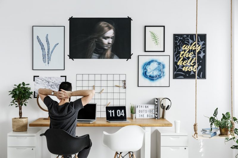 Man at Desk Artwork on Wall