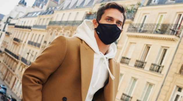 Vincent Lacrocq steps out in a face mask as he dons a hoodie and double-breasted coat from Mango's Comfy collection.