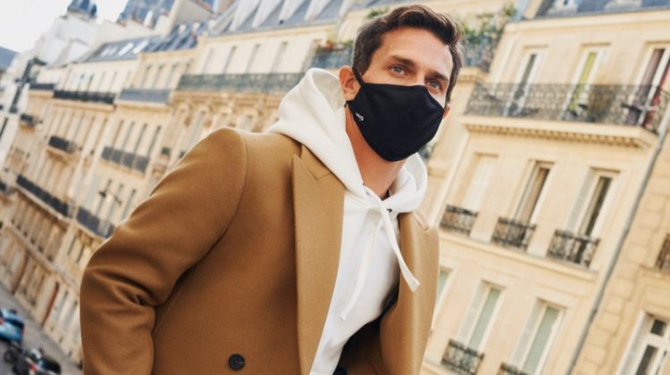 Vincent Lacrocq steps out in a face mask as he dons a hoodie and double-breasted coat from Mango's Comfy collection.