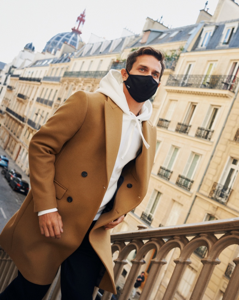 Vincent Lacrocq steps out in a face mask as he dons a hoodie and double-breasted coat from Mango's Comfy collection.