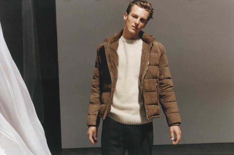 Quentin Demeester wears a brown puffer jacket with a crewneck sweater from Massimo Dutti's fall-winter 2020 Limited Edition men's collection.