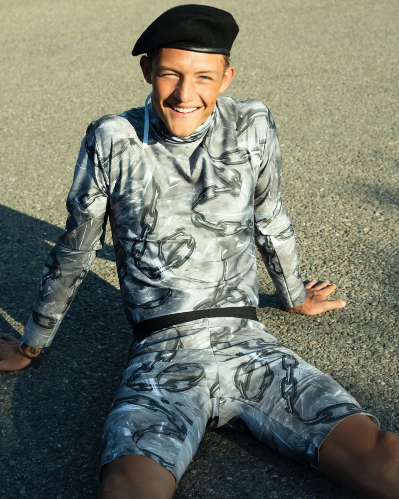 All smiles, Oliver wears a sporty all-over printed look from Jean Phillip.