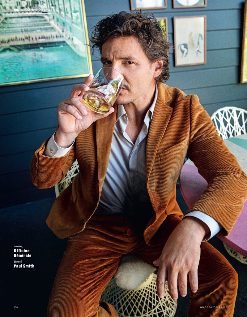 Enjoying a drink, Pedro Pascal sports a corduroy suit by Officine Générale. Photographed for GQ Germany, he also wears a Paul Smith shirt.