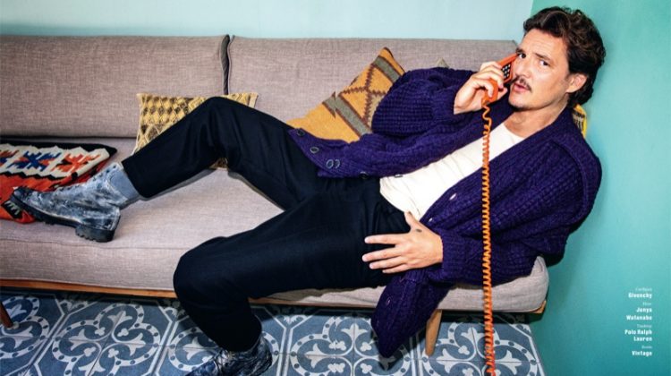 Taking a phone call, Pedro Pascal dons a cardigan sweater by Givenchy. Posing for GQ Germany, Pascal's look is complete with Junya Watanabe pants, a POLO Ralph Lauren tank, and vintage boots.