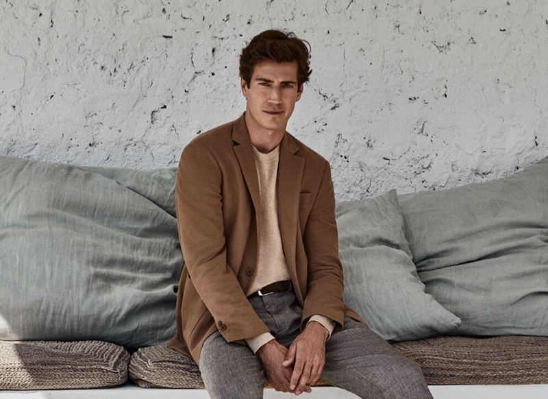 Oriol Elcacho dons a smart suit jacket over a crewneck sweater with trousers from Pedro del Hierro's pre-fall 2020 collection.