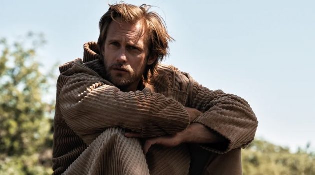 Alexander SkarsgaÌŠrd Covers L'Uomo Vogue, Talks 'The Northman' Actor Alexander SkarsgaÌŠrd sports a corduroy coat and joggers from Dolce & Gabbana for L'Uomo Vogue. He also wears Clarks desert boots.