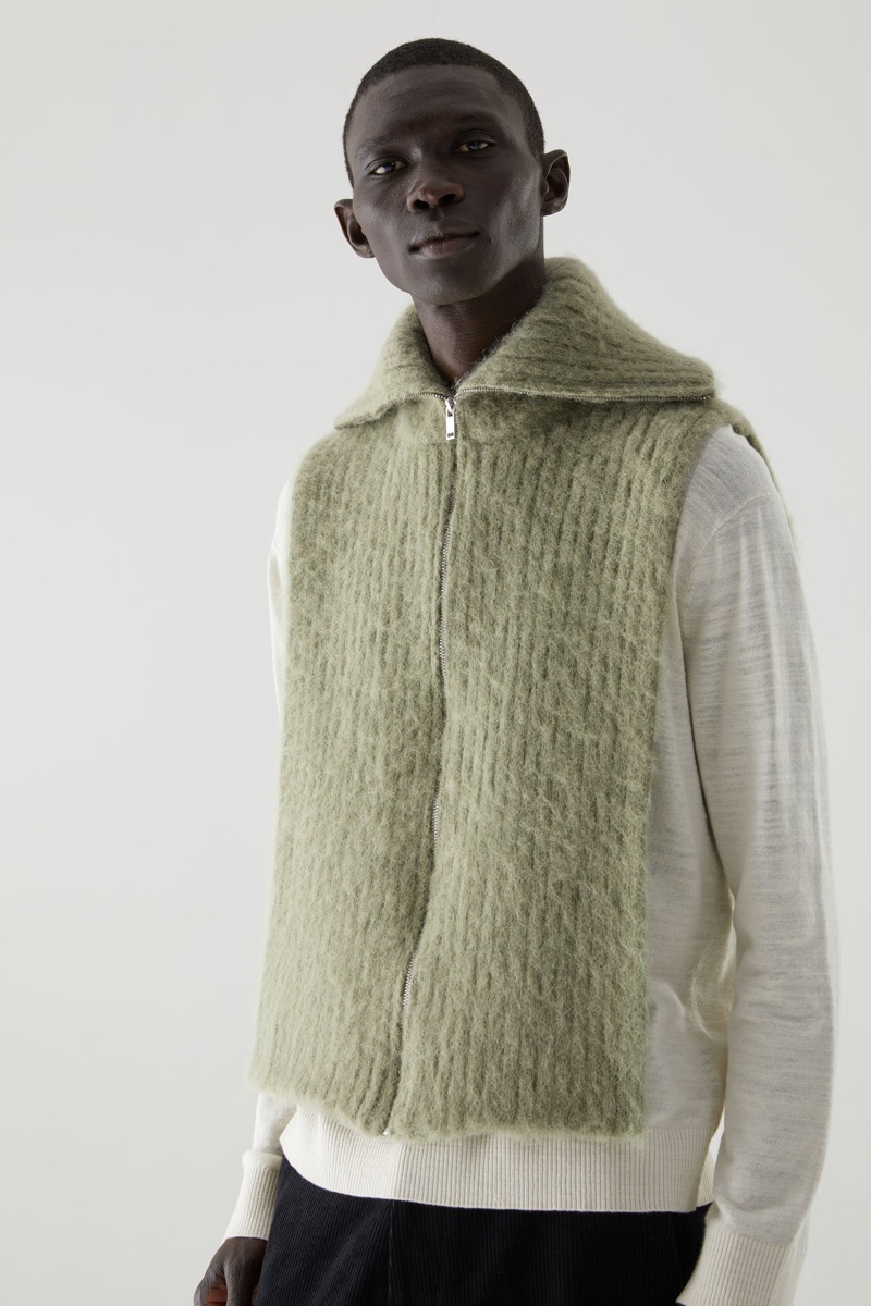 Fernando Cabral dons a wool-alpaca mix scarf-vest hybrid from COS' fall-winter 2020 collection. 