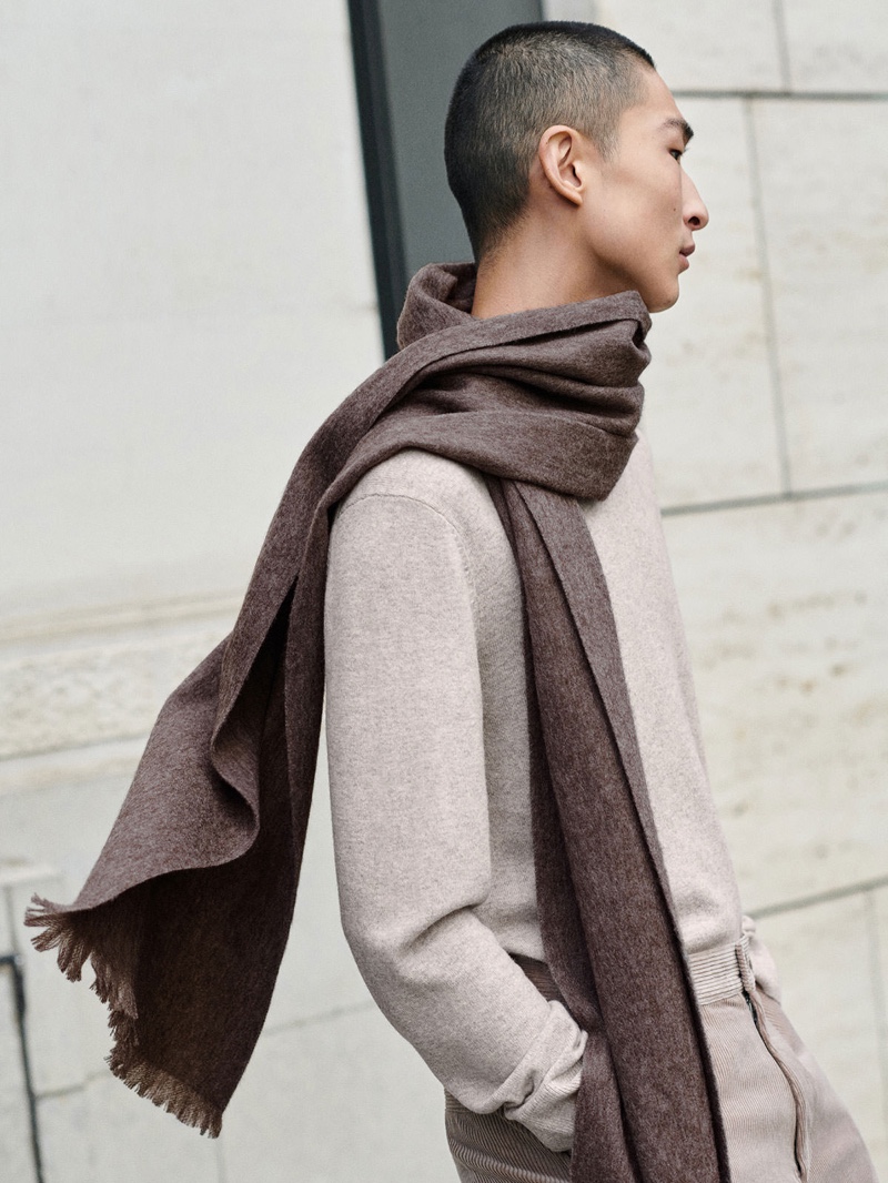 Korean model Sang Woo Kim makes a case for autumnal tones in a yak hair woolen scarf and merino yak hair sweater with corduroy pants from COS.