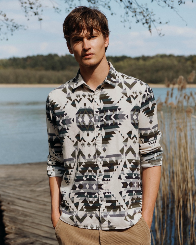 Front and center, Frederik Ruegger dons a printed shirt for Esprit's fall-winter 2020 campaign.
