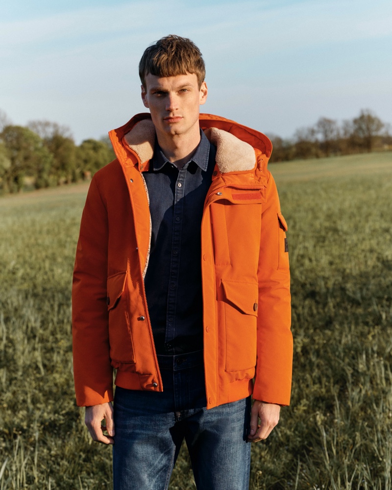 Max Bender rocks an orange hooded jacket for Esprit's fall-winter 2020 campaign.