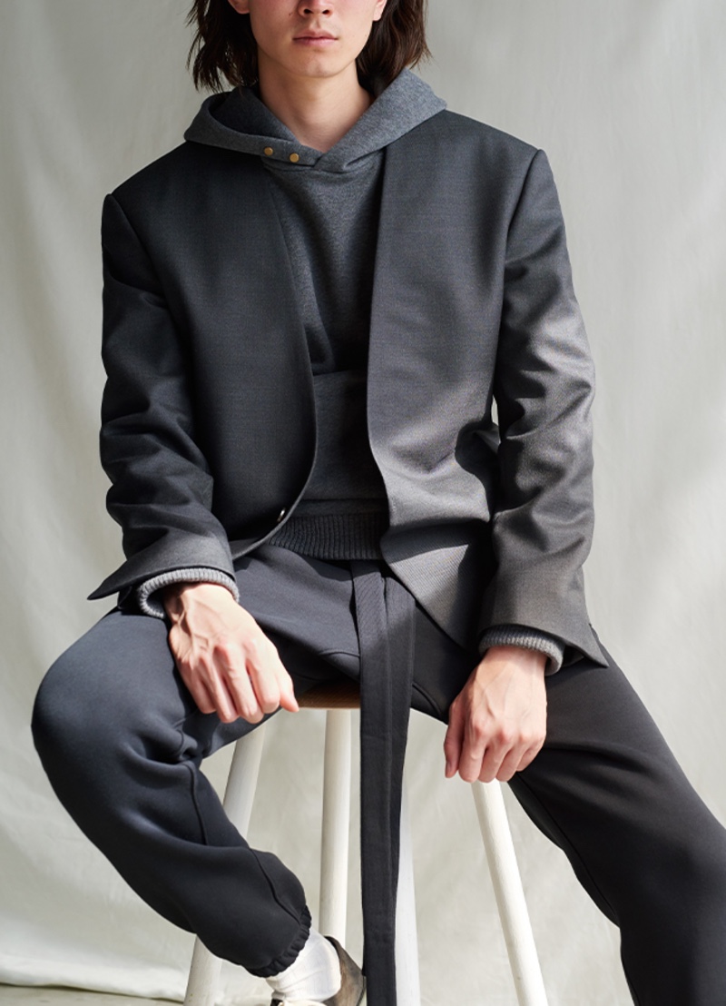 Formal and casual worlds collide with a slim-fit collarless wool blazer and belted cotton-blend jersey track pants from the Fear of God for Ermenegildo Zegna collection.