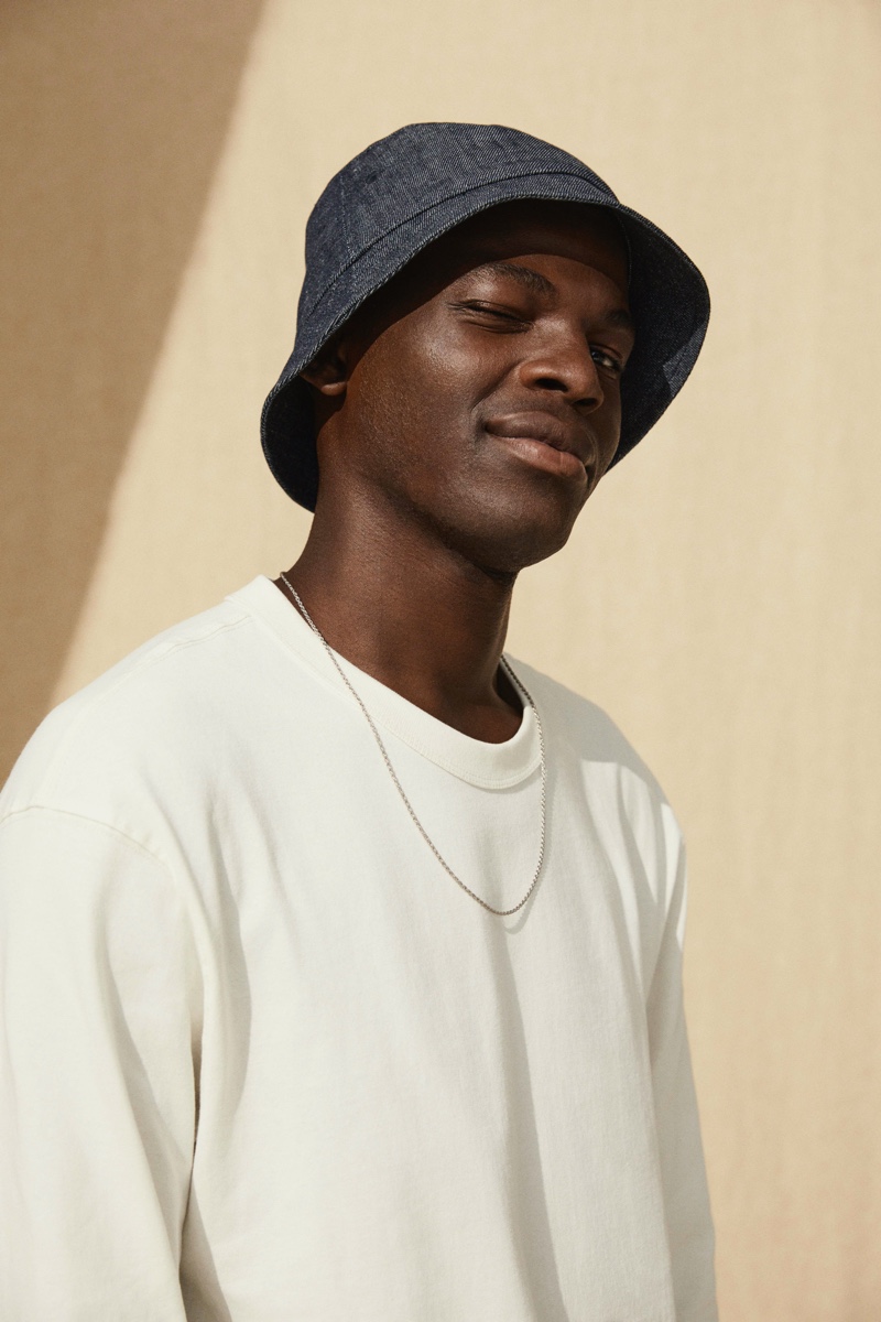 Model Evandro Laurens sports a denim bucket hat from H&M's Jeans Redesign collection.