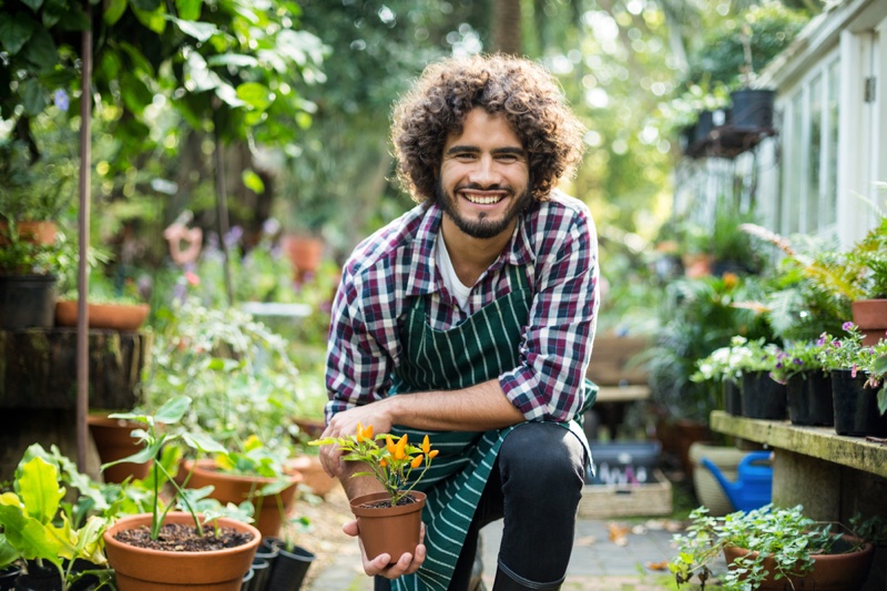 Happy Smiling Male Gardener Greenhouse Potted Plant