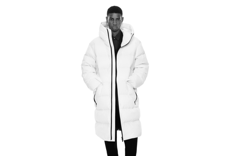 Ready to turn heads, Louis Dicko wears a white puffer coat for the fall-winter 2020 UNIQLO +J campaign.