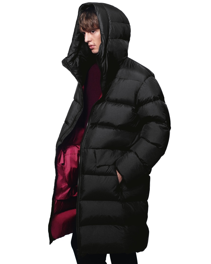 Dressed for the cold, Leon Dame sports a hooded puffer from the fall-winter 2020 UNIQLO +J collection.