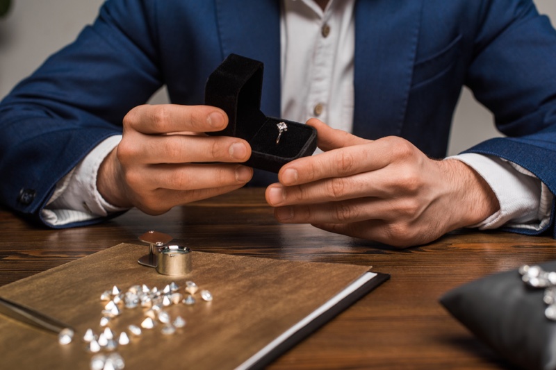 Man Holding Engagement Ring Diamonds