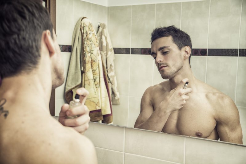 Man Putting on Cologne Man Putting on Cologne