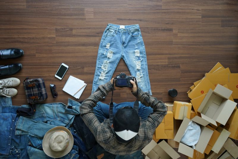 Man Taking Photos of Jeans