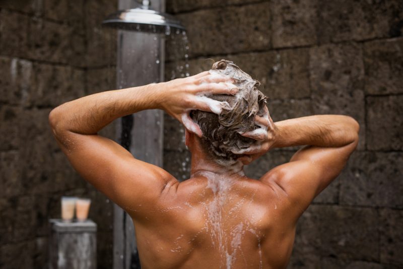 Man Washing Hair and Conditioning