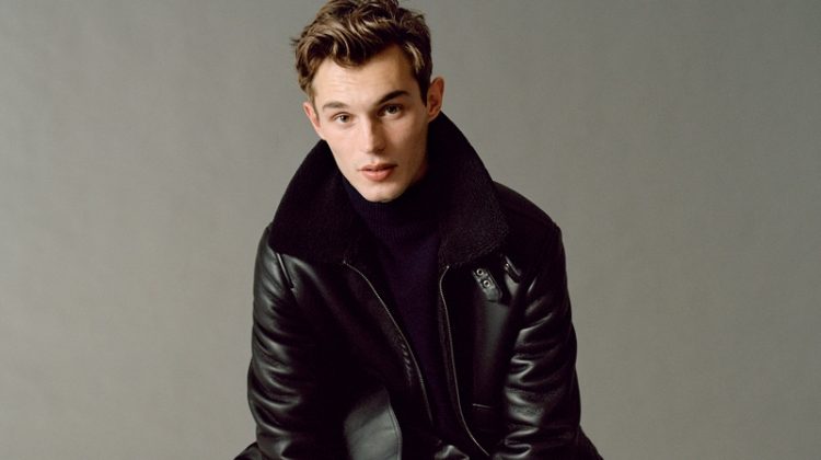 Kit Butler embraces contemporary style in a look from Mango's fall-winter 2020 Urban Essentials collection. The British model takes to the studio where he sits for a portrait. He dons a Mango leather jacket with slim-fit pants, a turtleneck, and leather boots.