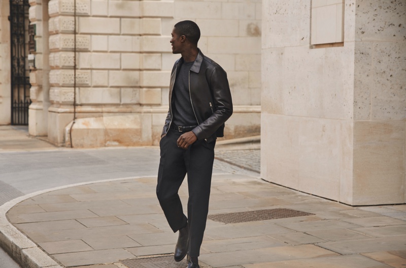 Wearing a leather jacket, James Kakonge models a fall-winter 2020 look from Mr Porter's Mr P. label.