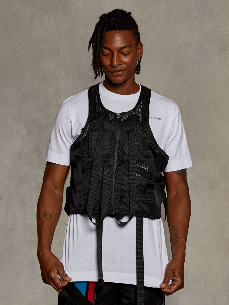 Tackling military-inspired style, Ty Ogunkoya models a 1017 ALYX 9SM t-shirt and vest with Feng Chen Wang trousers.