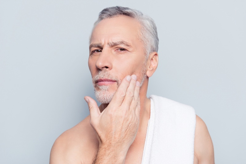 Older Male Model Grey Hair Touching Face Grooming