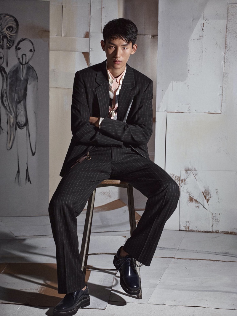 Jun Young Hwang dons a pinstripe suit with an abstract print shirt for Zara's fall-winter 2020 men's campaign.