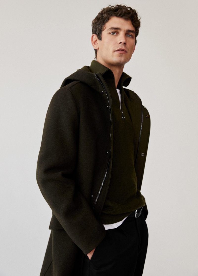 Arthur Gosse dons a long recycled wool coat with a zip neck sweater from Mango Man.